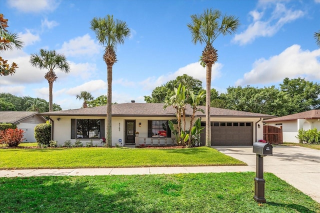 5162 Tellson Pl, Orlando, FL 32812 - ranch-style home featuring fence, a front yard, stucco siding, concrete driveway, and an attached garage