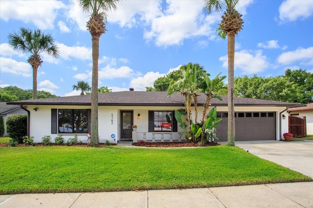 5162 Tellson Pl, Orlando, FL 32812 - ranch-style home featuring covered porch, a front yard, concrete driveway, an attached garage, and stucco siding