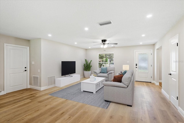 5162 Tellson Pl, Orlando, FL 32812 - living room featuring light wood finished floors and visible vents