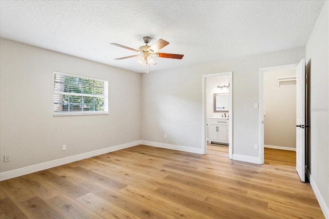 5162 Tellson Pl, Orlando, FL 32812 - unfurnished bedroom with ceiling fan, a textured ceiling, baseboards, light wood finished floors, and ensuite bath