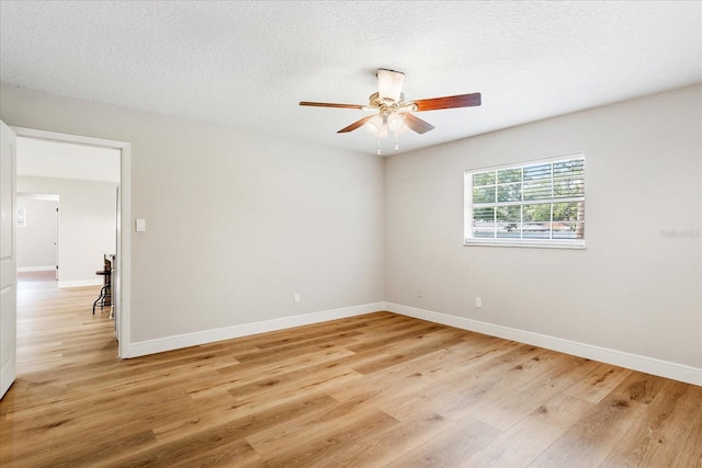 5162 Tellson Pl, Orlando, FL 32812 - spare room featuring a ceiling fan, baseboards, a textured ceiling, and light wood-style floors