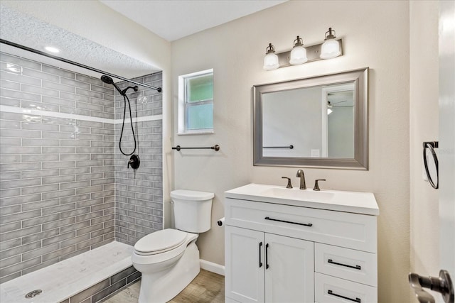 5162 Tellson Pl, Orlando, FL 32812 - full bath featuring vanity, toilet, baseboards, wood finished floors, and tiled shower