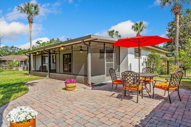 5162 Tellson Pl, Orlando, FL 32812 - back of property featuring ceiling fan, fence, a sunroom, a patio area, and outdoor dining space