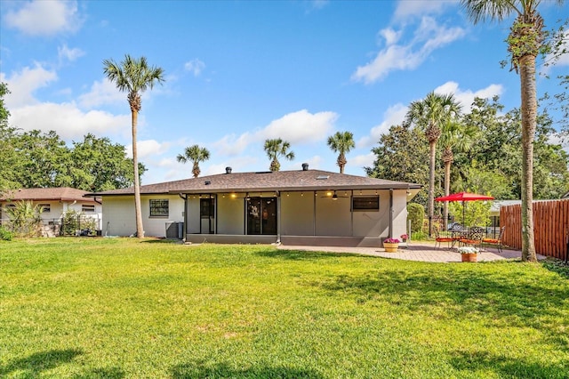 5162 Tellson Pl, Orlando, FL 32812 - rear view of house featuring a lawn, a patio, fence, and a sunroom
