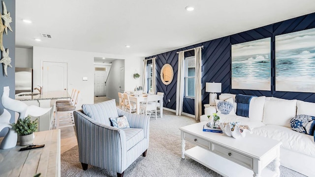 living room featuring carpet, recessed lighting, and visible vents
