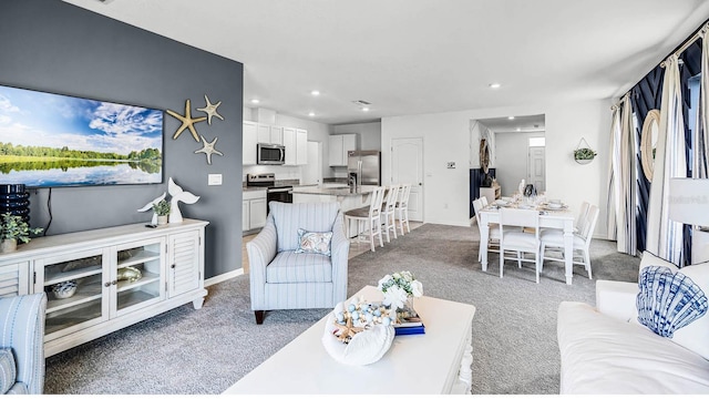living room with recessed lighting and light colored carpet