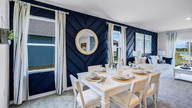dining space featuring carpet and a textured ceiling