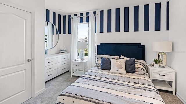 bedroom with baseboards and carpet