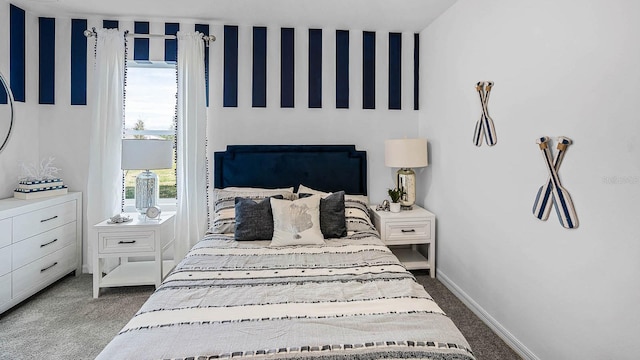 bedroom with baseboards and carpet