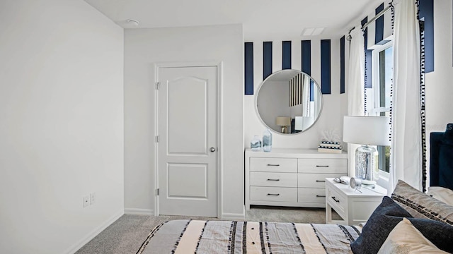 bedroom with baseboards and light carpet