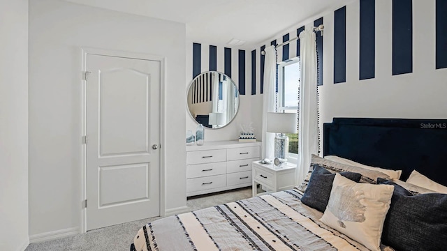 bedroom featuring baseboards and light colored carpet