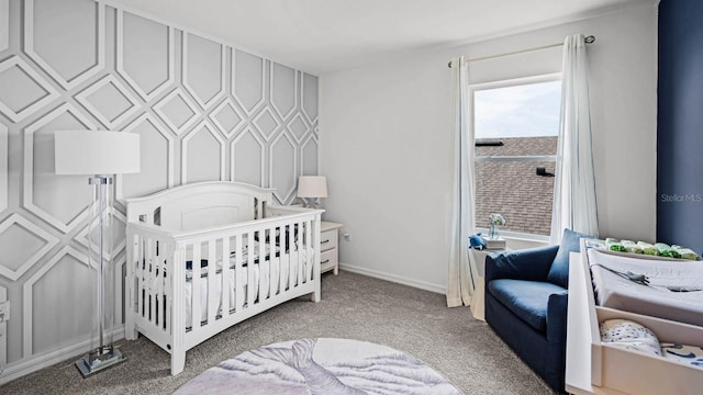 bedroom featuring light colored carpet and baseboards