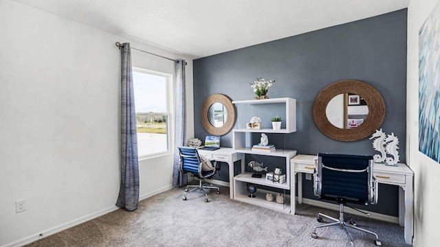carpeted office space featuring baseboards