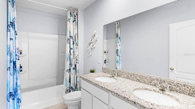 full bath featuring double vanity, a sink, shower / tub combo with curtain, and toilet