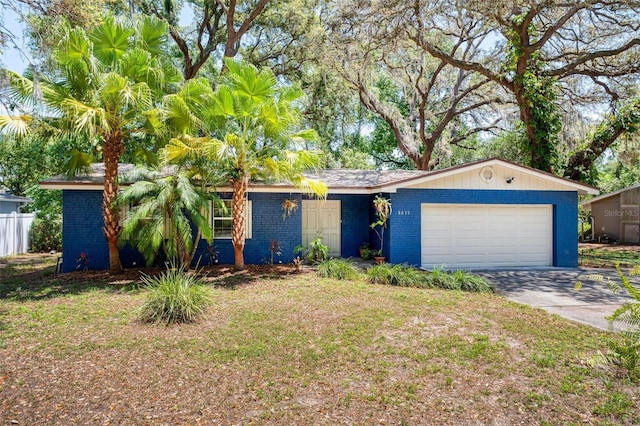 8619 Veridian Dr, Orlando, FL 32810 - ranch-style house featuring brick siding, an attached garage, fence, and driveway