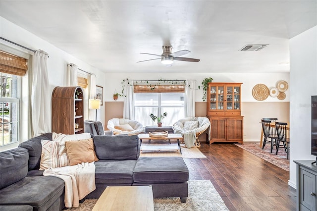 8619 Veridian Dr, Orlando, FL 32810 - living area featuring a healthy amount of sunlight, ceiling fan, dark wood finished floors, and visible vents