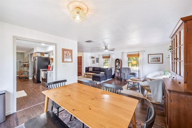 8619 Veridian Dr, Orlando, FL 32810 - dining room featuring ceiling fan, visible vents, and dark wood finished floors