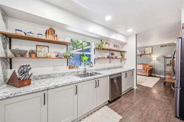 8619 Veridian Dr, Orlando, FL 32810 - kitchen with stainless steel appliances, open shelves, a sink, and dark wood-type flooring