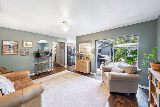 8619 Veridian Dr, Orlando, FL 32810 - living room with baseboards and dark wood-style floors