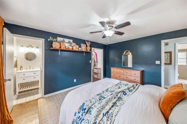 8619 Veridian Dr, Orlando, FL 32810 - bedroom featuring connected bathroom, a ceiling fan, baseboards, wood finished floors, and a closet