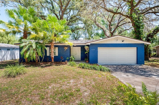 8619 Veridian Dr, Orlando, FL 32810 - single story home featuring a garage, fence, driveway, and brick siding