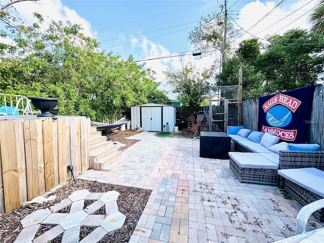 116 Lincoln Ave Unit 116-118, Cape Canaveral, FL 32920 - fenced backyard featuring a storage unit, a patio area, and an outdoor hangout area
