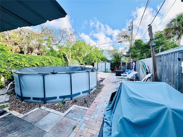 116 Lincoln Ave Unit 116-118, Cape Canaveral, FL 32920 - fenced backyard featuring a storage unit and a patio