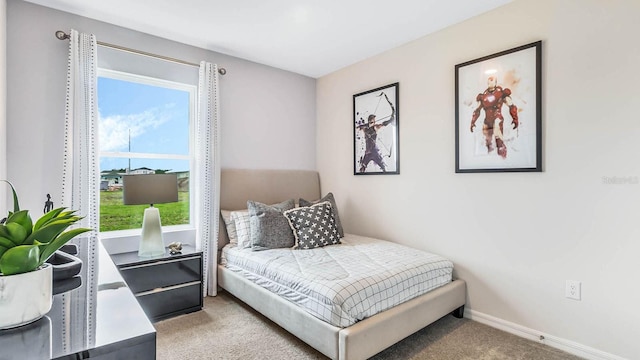 carpeted bedroom featuring baseboards