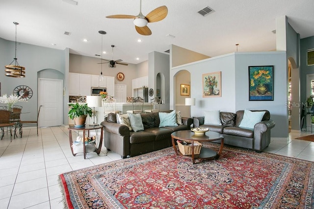 4219 Lillian Hall Ln, Orlando, FL 32812 - living room featuring arched walkways, high vaulted ceiling, a ceiling fan, light tile patterned floors, and visible vents