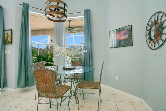 4219 Lillian Hall Ln, Orlando, FL 32812 - dining space featuring baseboards, tile patterned flooring, and ceiling fan with notable chandelier