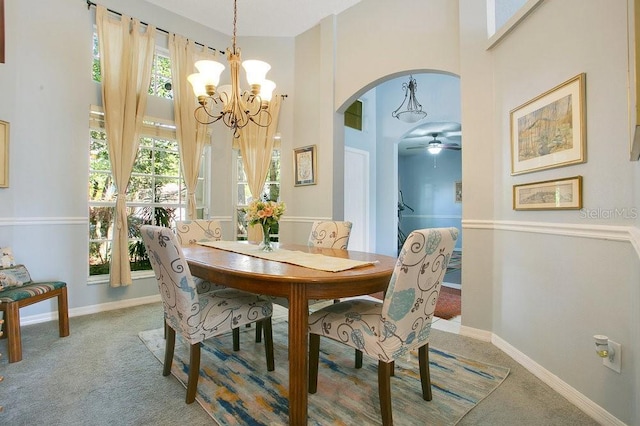 4219 Lillian Hall Ln, Orlando, FL 32812 - carpeted dining area featuring arched walkways, baseboards, ceiling fan with notable chandelier, and a towering ceiling