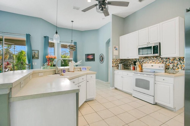 4219 Lillian Hall Ln, Orlando, FL 32812 - kitchen featuring visible vents, white range with electric cooktop, tasteful backsplash, a sink, and stainless steel microwave
