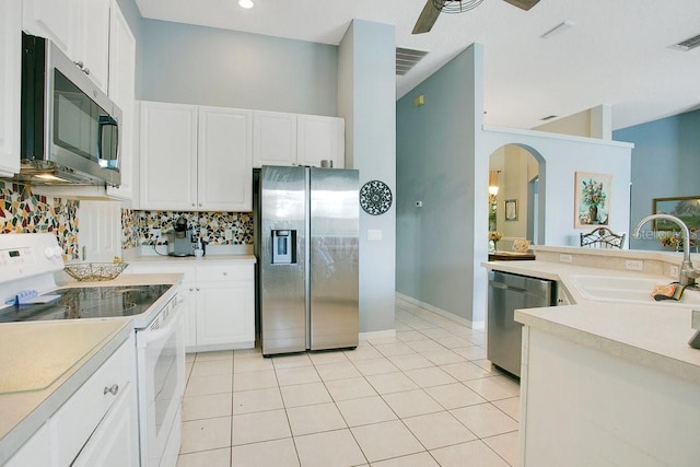 4219 Lillian Hall Ln, Orlando, FL 32812 - kitchen with light countertops, stainless steel appliances, arched walkways, and a sink