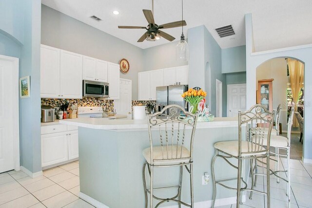 4219 Lillian Hall Ln, Orlando, FL 32812 - kitchen featuring light tile patterned floors, ceiling fan, stainless steel appliances, and visible vents