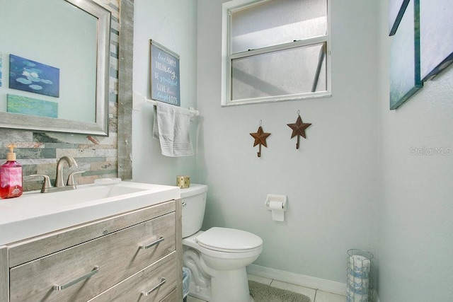 4219 Lillian Hall Ln, Orlando, FL 32812 - half bath with vanity, toilet, tile patterned floors, baseboards, and backsplash