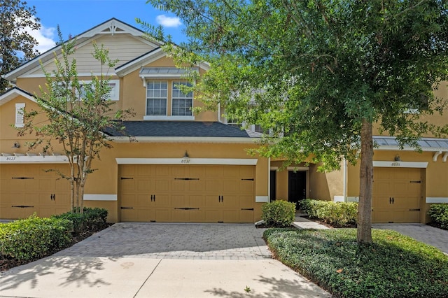 8031 Enchantment Dr Unit Ge, Windermere, FL 34786 - view of front of home featuring driveway, stucco siding, and a garage