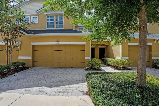 8031 Enchantment Dr Unit Ge, Windermere, FL 34786 - view of front of house featuring a garage, stucco siding, and decorative driveway