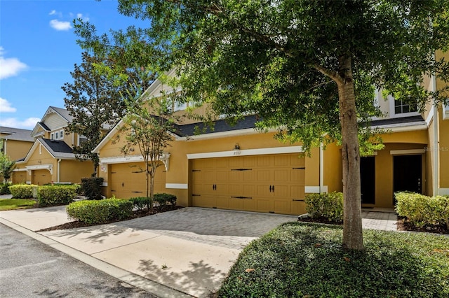 8031 Enchantment Dr Unit Ge, Windermere, FL 34786 - view of front of property featuring driveway, stucco siding, and an attached garage