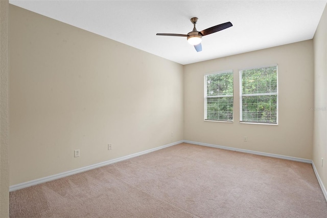 8031 Enchantment Dr Unit Ge, Windermere, FL 34786 - spare room with baseboards, a ceiling fan, and light colored carpet