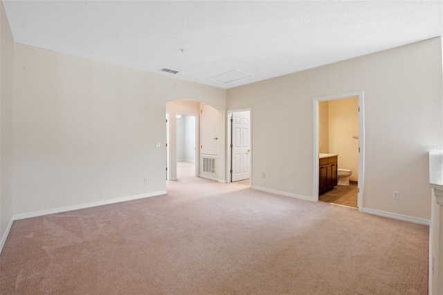 8031 Enchantment Dr Unit Ge, Windermere, FL 34786 - interior space with light colored carpet, visible vents, baseboards, and arched walkways