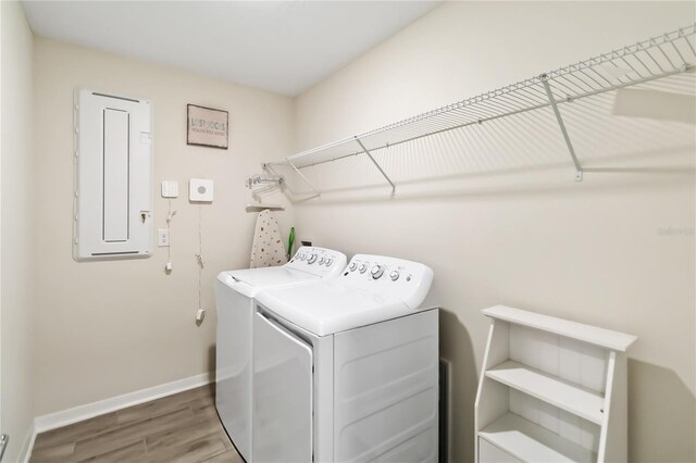 5347 Travertine St, Mount Dora, FL 32757 - laundry room with separate washer and dryer, wood finished floors, baseboards, and electric panel