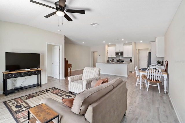 5347 Travertine St, Mount Dora, FL 32757 - living room featuring a ceiling fan, baseboards, recessed lighting, and light wood-style floors
