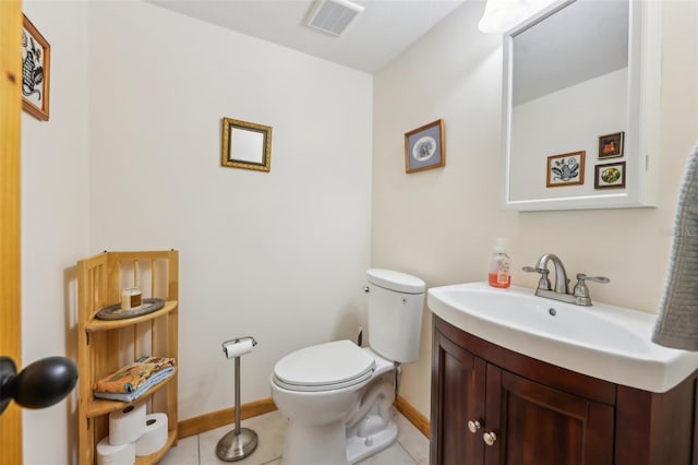 half bathroom featuring visible vents, tile patterned flooring, vanity, toilet, and baseboards