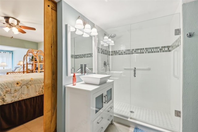 bathroom with ensuite bathroom, a ceiling fan, a stall shower, and vanity