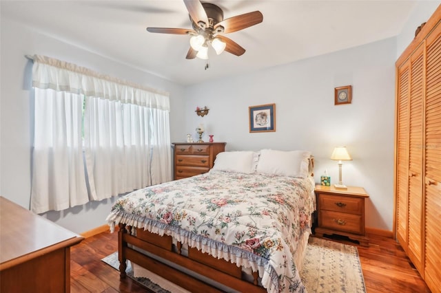 bedroom featuring baseboards, a closet, and wood finished floors
