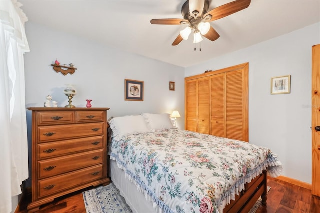 bedroom featuring a closet, dark wood-type flooring, and ceiling fan