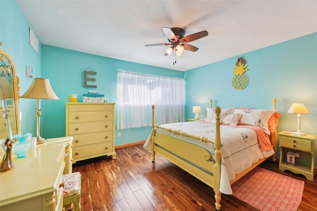 bedroom featuring a ceiling fan, baseboards, visible vents, and wood finished floors
