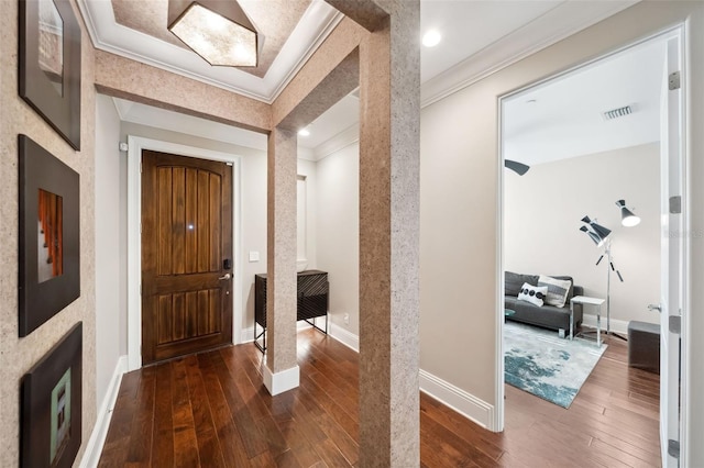 entrance foyer with dark wood-style flooring, baseboards, visible vents, and ornamental molding