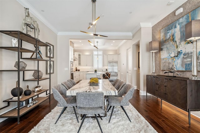 dining space featuring crown molding, baseboards, and dark wood finished floors
