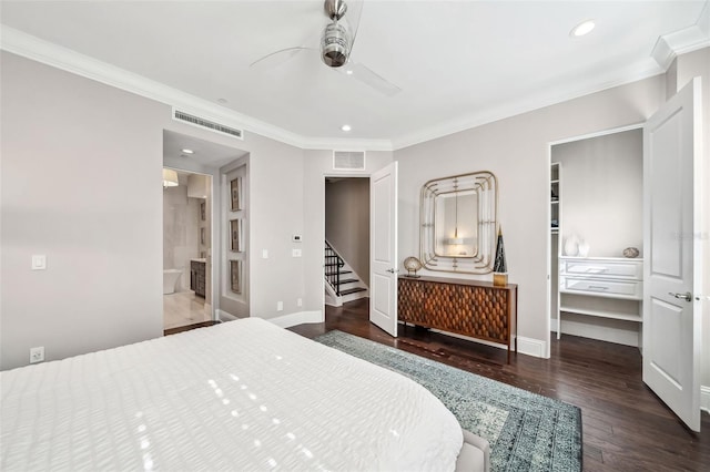 bedroom featuring crown molding, baseboards, visible vents, and wood finished floors